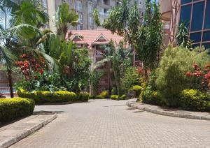 a courtyard of a building with trees and plants at La Pace One Bedroom Home, Rhapta Road Westlands Nairobi in Nairobi