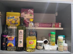 a shelf in a refrigerator filled with bottles and other ingredients at Paisible logement indépendant avec jardin et places de parking in Tarbes
