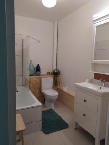 a bathroom with a toilet and a sink and a tub at studioleyme in Leyme