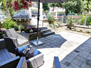 a patio with two chairs and an umbrella at Апартамент Tiana in Tsarevo