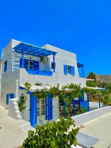 a blue and white house with blue doors at Sunrise Apartments Mikri Vigla Naxos 1 in Mikri Vigla