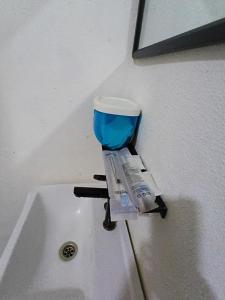a sink with a blue cup on top of it at Cassa Bonda Standard Double Room in Macang +10 photos