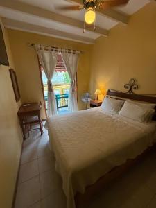 a bedroom with a large bed and a window at Hosteria Suiza in Ica +90 photos