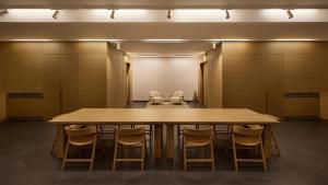 a conference room with a large wooden table and chairs at Mamula Island by Banyan Tree in Herceg-Novi +39 photos