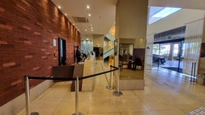 a lobby with a staircase and a brick wall at ApartHotel no Centro de Brasília in Brasilia +45 photos