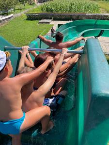 a group of people on a water slide at Cabana Iza in Bîrsana