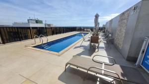 a balcony with a swimming pool on top of a building at ApartHotel no Centro de Brasília in Brasilia