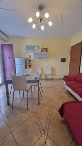 a living room with a table and chairs and a couch at Pascoli Apartment - Pula in Pula