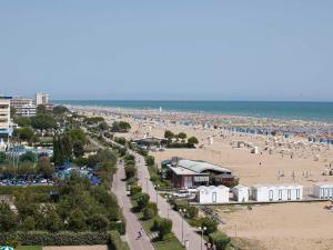 a view of a beach with a lot of people at NAONIS - Appartamenti in Bibione +12 photos