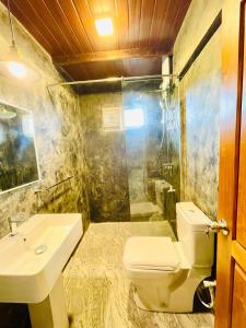 a bathroom with a toilet and a sink at Heavenly Horizon Villa in Kandy +23 photos
