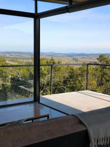 a room with a large glass window with a bench at Villa Toscana II - Excelentes Vistas y Confort in Villa Serrana