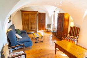 a living room with a blue couch and chairs at Belle maison en pierre - Saint-Crépin - Guillestre - Queyras in Saint-Crépin +20 photos