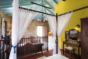 A bed or beds in a room at Klymeni Traditional Homes