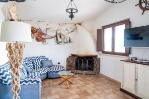 a living room with a couch and a fireplace at Villa Aratza in Orosei