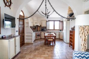 a kitchen with a table and chairs in it at Villa Aratza in Orosei