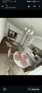 a picture of a living room with a table and chairs at Meraki Resort & Spa Isabellae Home in Mamaia Nord