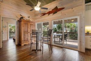 a dining room with a ceiling fan and a table with chairs at 1 Old House Cay - Private Island Oasis in Hilton Head Island +31 photos