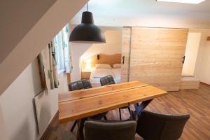 a dining room with a wooden table and chairs at Nationalpark Gesäuse Lodge in Gstatterboden