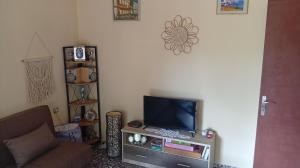 A television and/or entertainment centre at ''Mary's House'' Entire residence Olympiada Halkidiki Near to Sea 200m !