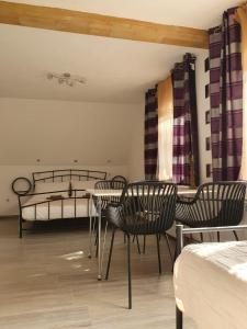 a room with chairs and a bed and a table at Guesthouse Nikola in Plitvička Jezera