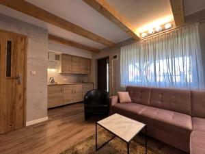 a living room with a couch and a table at U Zgagi in Mikoszewo