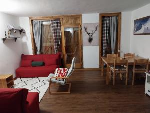 a living room with a red couch and a table at Casa Cornella cir226 in Pila