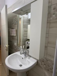 a bathroom with a white sink and a mirror at Sani Apartment in Golem
