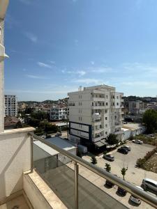 a balcony of a building with a parking lot at Sani Apartment in Golem
