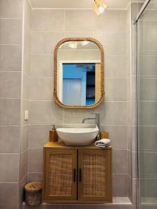 a bathroom with a sink and a mirror at La bohème Studio in La Grande-Motte +20 photos