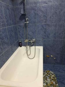 a shower in a bathroom with a tub at Park View Apartment Batumi in Batumi