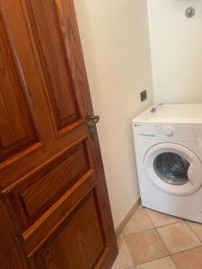 a door to a laundry room with a washing machine at Maison Linda in Santa Teresa Gallura
