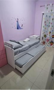 two beds in a room with a princess wall at Aurora sul mare in Terracina