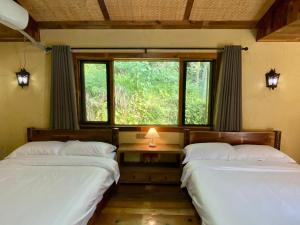 Voodi või voodid majutusasutuse Zhejiang Anji Xiaoshe B&B Near Zhejiang North Grand Canyon Deep Creek Canyon Rafting Jiangjunguan Rafting Wind Paragliding Zhangli Ancient Road Longwangshan Scenic Area toas