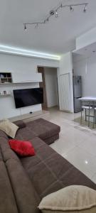 a living room with a couch and a tv at Aurora sul mare in Terracina