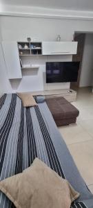 a living room with a couch and a flat screen tv at Aurora sul mare in Terracina +11 photos