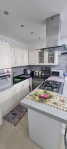 a kitchen with white cabinets and a stove top oven at Aurora sul mare in Terracina