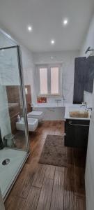 a bathroom with two sinks and a shower and two toilets at Aurora sul mare in Terracina