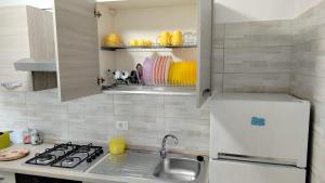 a small kitchen with a sink and a refrigerator at Dimora felice 2 - centro storico in Vasto