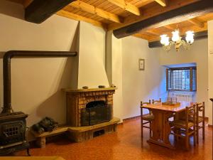 a living room with a fireplace and a dining room table at Casa Van Lente in Capranica