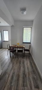 an empty room with a table and chairs in it at Vera Home 3 in Râmnicu Vâlcea