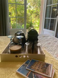 a box sitting on top of a bed with a book at La Vagabonde in Saint-Tropez