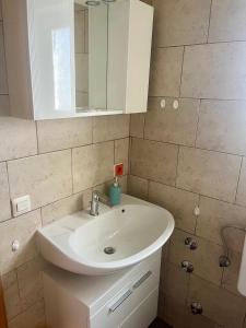 a bathroom with a white sink and a mirror at Krišto Croatia in Kaštela +42 photos