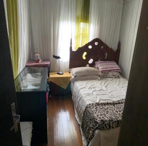 Ένα ή περισσότερα κρεβάτια σε δωμάτιο στο Casa Vovó Slaviero