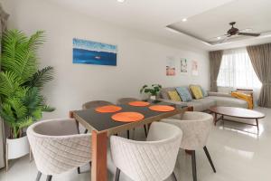a living room with a table and chairs and a couch at 3BDR Townhouse in Laguna Park in Bang Tao Beach