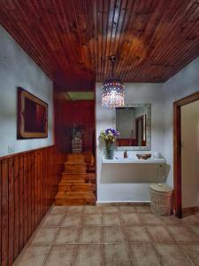 a hallway with a wooden ceiling and a staircase with a mirror at CASA TERESA in Camaleño