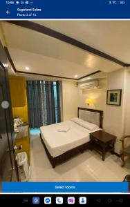a bedroom with a bed and a table in it at Sugarland Suites in Ormoc