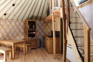 a room with a staircase in a yurt at Gite Le Mas Rigal in Saint-Amans-des-Cots