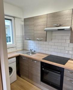 a kitchen with a sink and a washing machine at Studio Cannes in Le Cannet