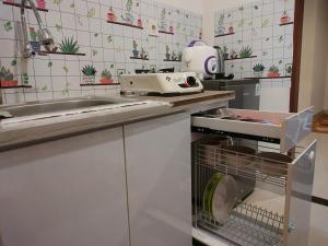 a kitchen with a sink and a machine on a counter at Apartment Grand Kamala Lagoon by Sato Room in Pulosirih