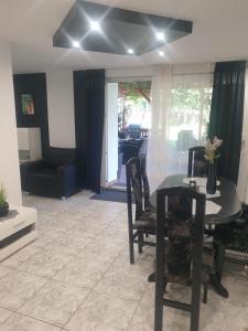 a living room with a black table and chairs at Pension u Danuśki z Bogdańca in Lubawka +17 photos